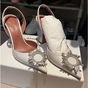 ** sold. Amina Muaddi Begum slings 38.5